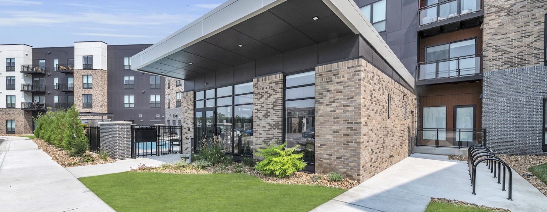 a building with a walkway and grass
