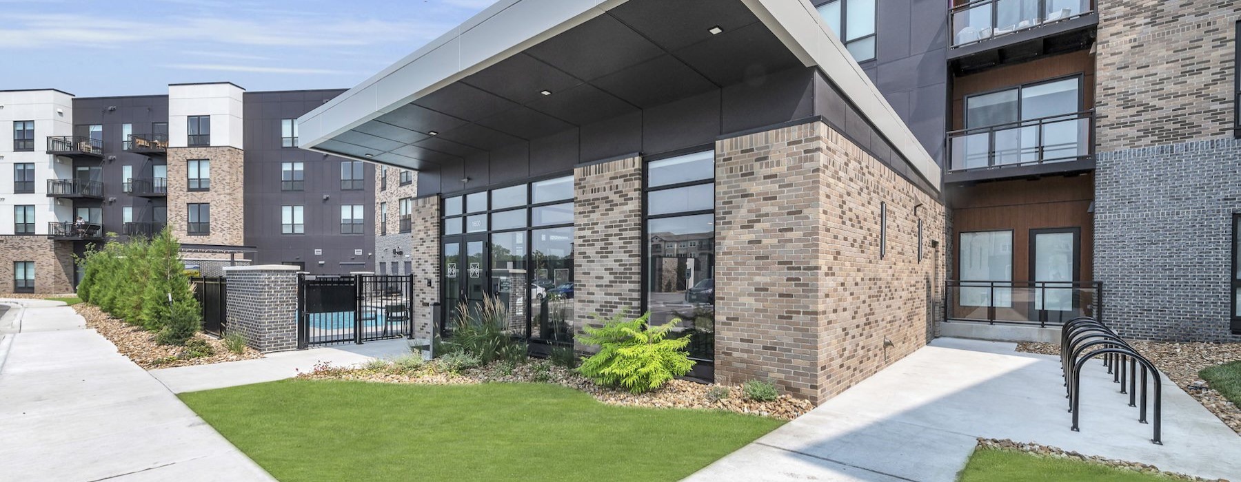 a building with a walkway and grass